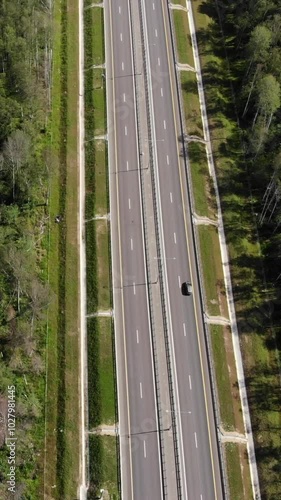 Trucks and cars at the highway in the forest. Aerial view.