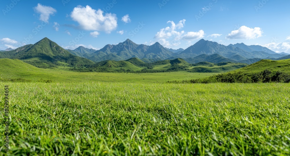 Lush green mountain landscape with blue sky and clouds Lush green mountain landscape with blue sky and clouds