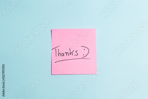 A pink sticky note with the word "THANKS" written on it