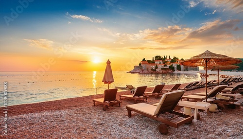 Obraz na płótnie captivating sunset at beach with chaise lounges and umbrellas in sveti stefan near budva w salonie