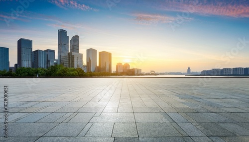 empty square floor and city skyline with modern commercial buildings in hangzhou at sunrise china