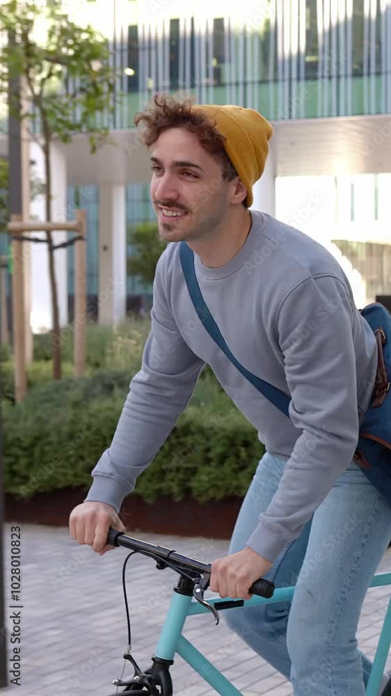 Vertical HD video of happy young student man leaving campus college after classroom riding his bicycle. Education, people and eco friendly transportation concept. Vertical HD video of happy young student man leaving campus college after classroom riding his bicycle. Education, people and eco friendly transportation concept.