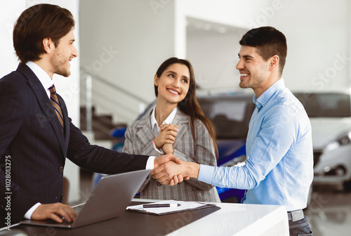 Wallpaper Mural Young Spouses Buying Car, Husband Handshaking With Seller Man Standing In Dealership Office. Selective Focus Torontodigital.ca