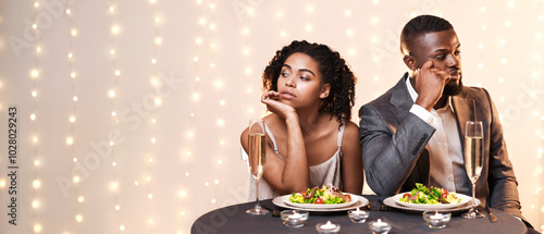 Afro man and woman being unhappy because of troubled date in restaurant