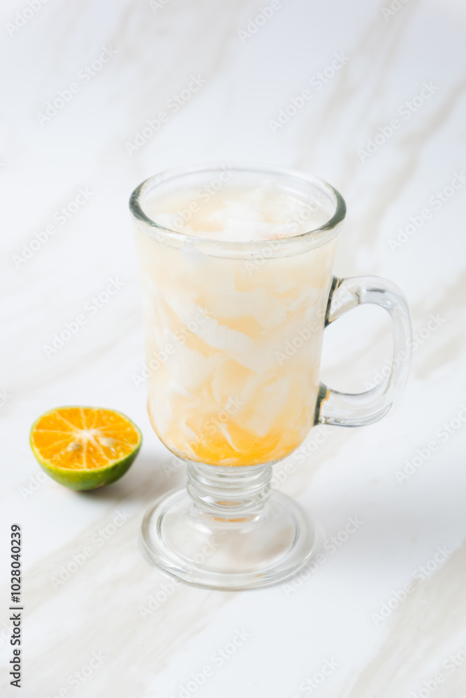 Es Kelapa Jeruk, a typical Indonesian drink made from fresh oranges squeezed with grated young coconut. with copy space. perfect for recipe, article, catalogue, or any commercial purposes. Es Kelapa Jeruk, a typical Indonesian drink made from fresh oranges squeezed with grated young coconut. with copy space. perfect for recipe, article, catalogue, or any commercial purposes.