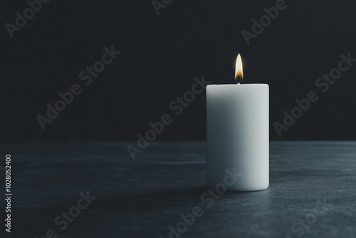 Wallpaper Mural Single white candle burning softly in a dark room creating a serene ambiance. Torontodigital.ca
