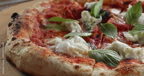 Margherita pizza with mozzarella cheese, tomato sauce, olive oil and basil leaves.