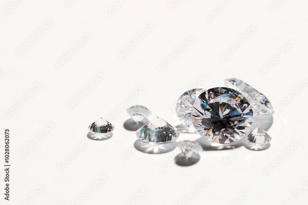 Many beautiful shiny diamonds on white background, closeup. Space for text Many beautiful shiny diamonds on white background, closeup. Space for text