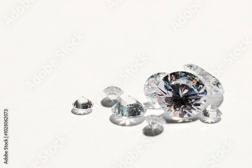 Many beautiful shiny diamonds on white background, closeup. Space for text