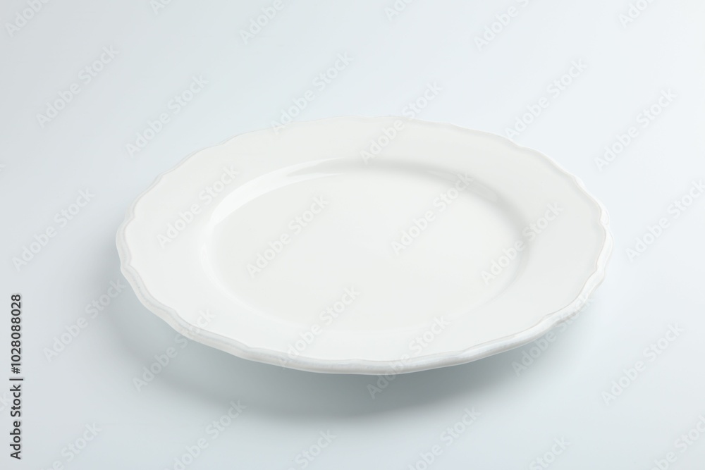 One empty ceramic plate isolated on white One empty ceramic plate isolated on white