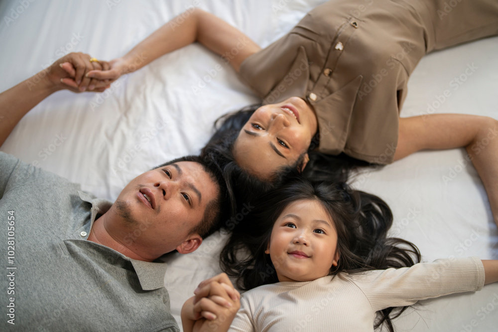 A joyful mother and daughter laughing together while lying on a bed. The playful moment showcases their strong bond and happiness in a comfortable home setting, surrounded by natural decor. A joyful mother and daughter laughing together while lying on a bed. The playful moment showcases their strong bond and happiness in a comfortable home setting, surrounded by natural decor.