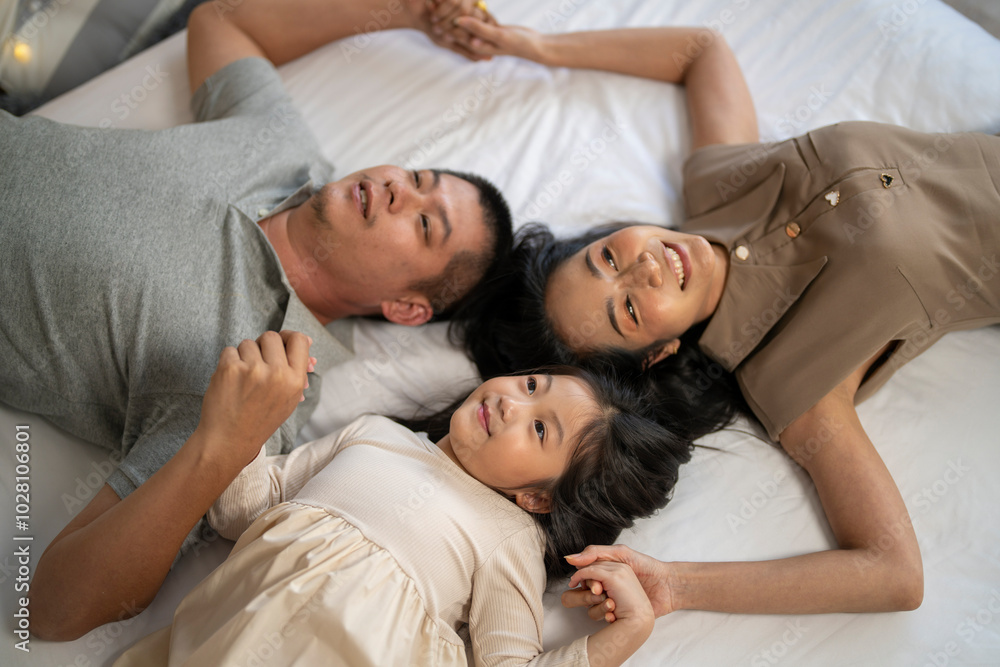 A joyful mother and daughter laughing together while lying on a bed. The playful moment showcases their strong bond and happiness in a comfortable home setting, surrounded by natural decor. A joyful mother and daughter laughing together while lying on a bed. The playful moment showcases their strong bond and happiness in a comfortable home setting, surrounded by natural decor.