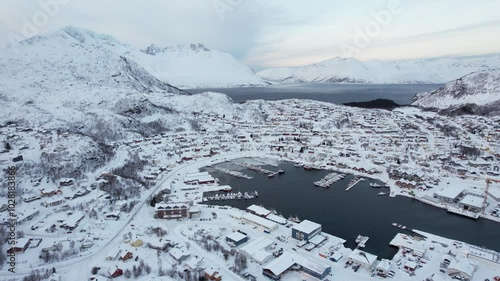 A typical Norwegian town covered in snow during winter. Filmed with a Drone in Skjervoy, a small town located on Skjervøy Island, Lapland, Northern Norway