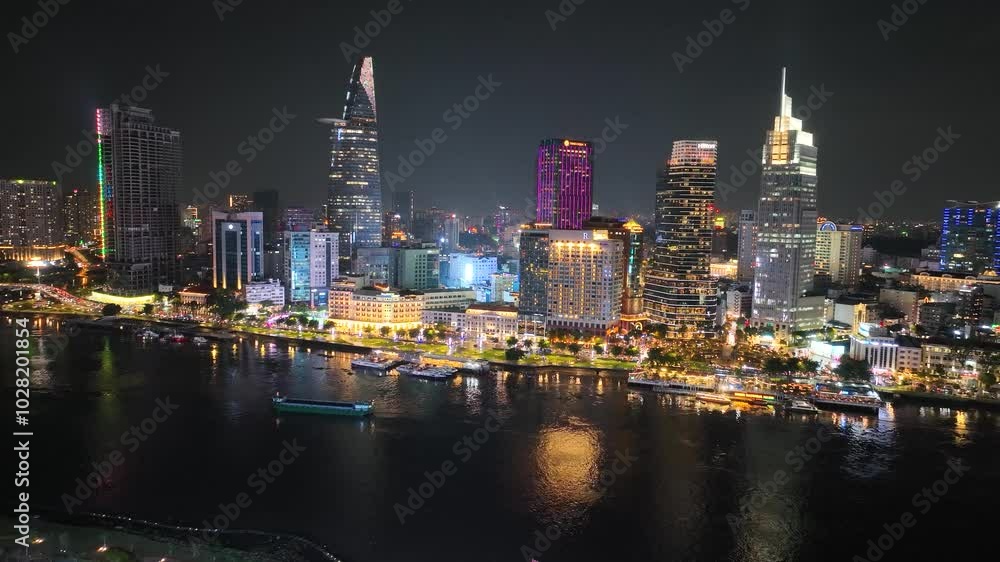 Saigon riverfront lit up at night with vibrant city skyline reflections in Ho Chi Minh City Vietnam Saigon riverfront lit up at night with vibrant city skyline reflections in Ho Chi Minh City Vietnam