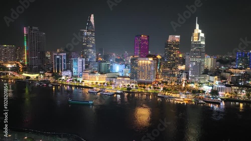Wallpaper Mural Saigon riverfront lit up at night with vibrant city skyline reflections in Ho Chi Minh City Vietnam Torontodigital.ca