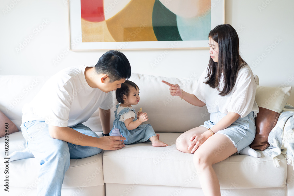 A 1 year old Taiwanese girl spending time playing happily with her parents, a man and woman in their 20s, in a room of a high rise apartment in Taichung City, Taiwan. A 1 year old Taiwanese girl spending time playing happily with her parents, a man and woman in their 20s, in a room of a high rise apartment in Taichung City, Taiwan.