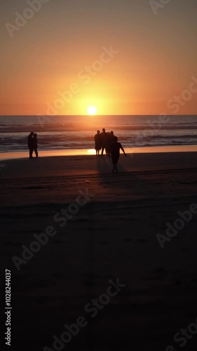 family silhouette and sunset on the beach