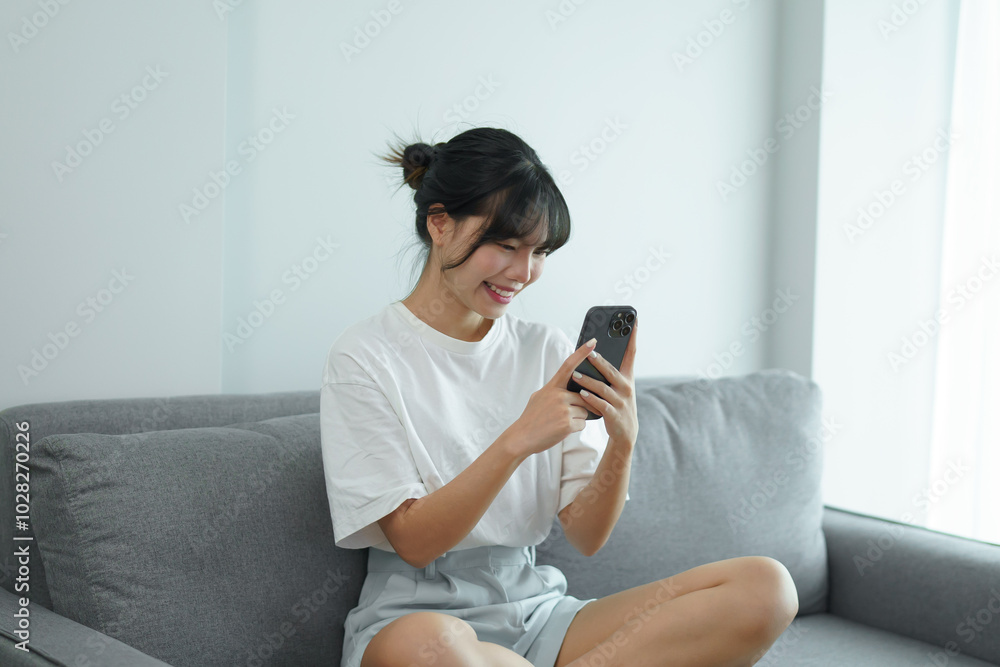 Asian woman using smart phone spending time checking news social media cell telephone technology e-commerce Asian woman using smart phone spending time checking news social media cell telephone technology e-commerce