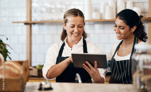 Business women, cafe and bakery with tablet for online service, order or review at indoor restaurant. Young, female people or waitress with smile on technology for revenue or profit at coffee shop