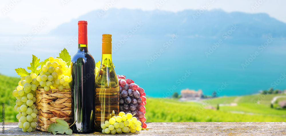 Fototapeta premium A basket filled with various types of grapes and bottles of red and white wine