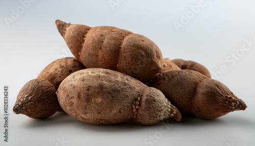  A bunch of small yams in different orientations, their rustic skins detailed and visible aga photo