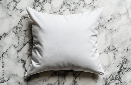 A white pillow on a marble background, perfect for adding your own design or text.