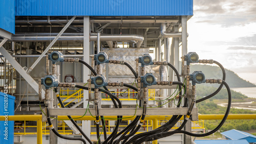 instrument transmitter measurement on power plant project. Close-up view of an industrial control panel with multiple sensors and gauges.