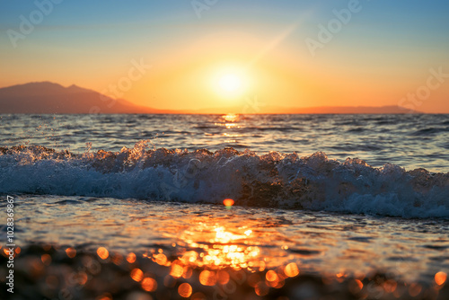 Aegean sea wave crashing at sandy beach of Vrasna, Greece photo