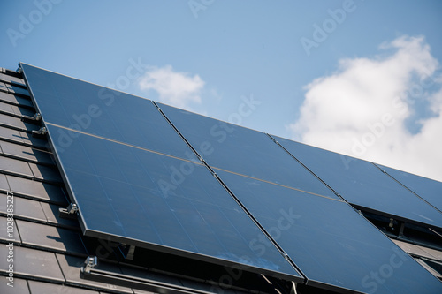 Solar panels installed under cloudy sky on rooftop