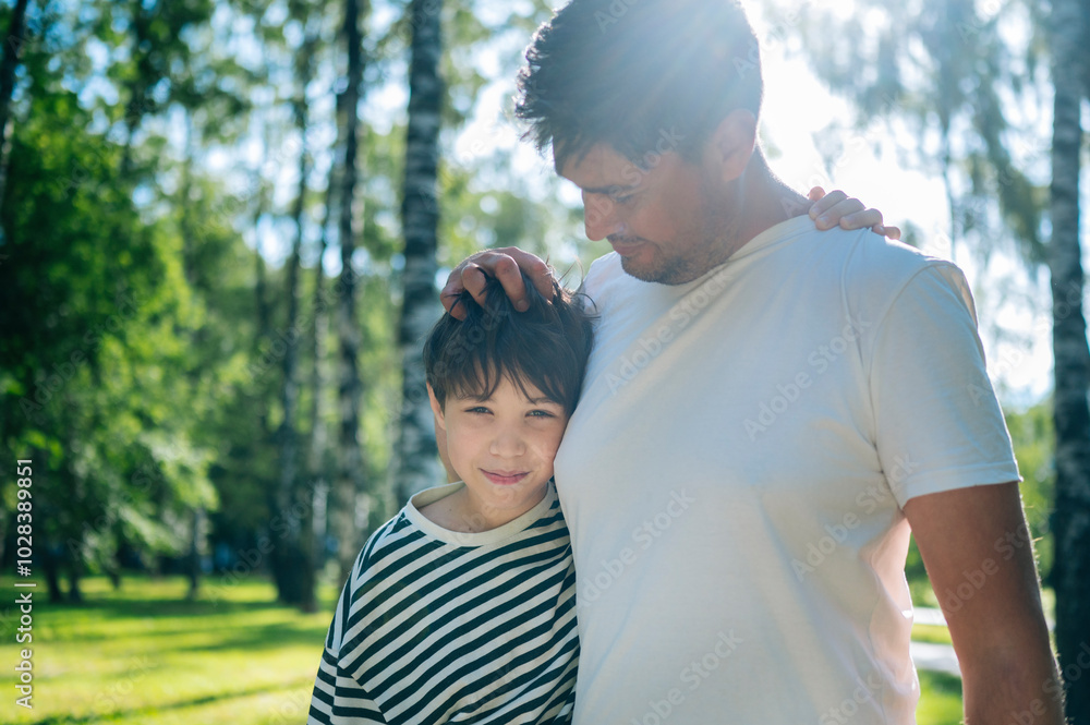 Father and son embracing at park Father and son embracing at park