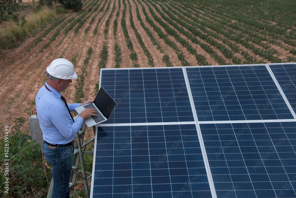 engineer with laptop on Solar panel clean energy. woman engineer checking solar cell with solar panel. engineer with laptop on Solar panel clean energy. woman engineer checking solar cell with solar panel.
