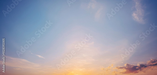 Breathtaking sunset sky with delicate clouds, showcasing a vibrant palette of pastel hues. Background photos for banners, posters and wallpapers.