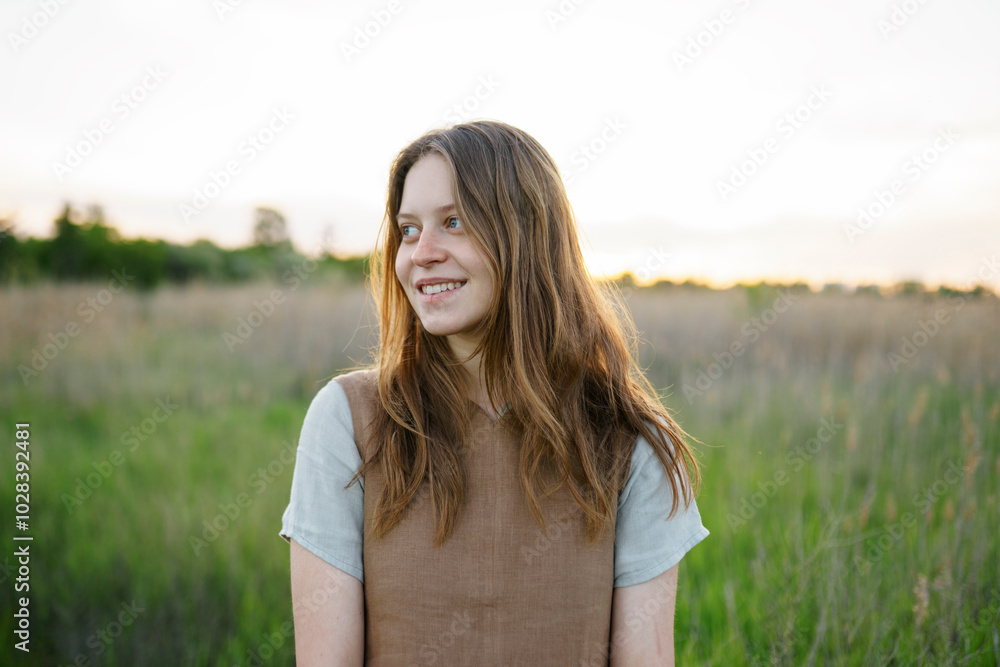 Smiling blond woman standing in meadow Smiling blond woman standing in meadow