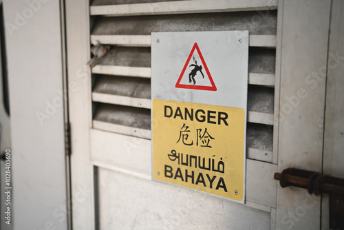 Electrical hazard warning signs in different languages ​​in Singapore