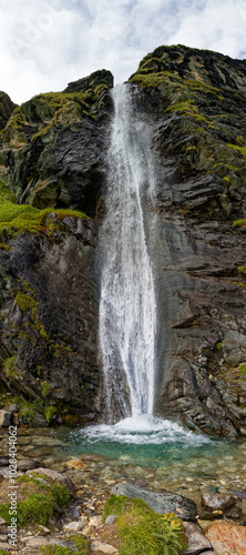 Vertical mountain panorama, waterfall in the Alps, Lombardy, Italy, Europe