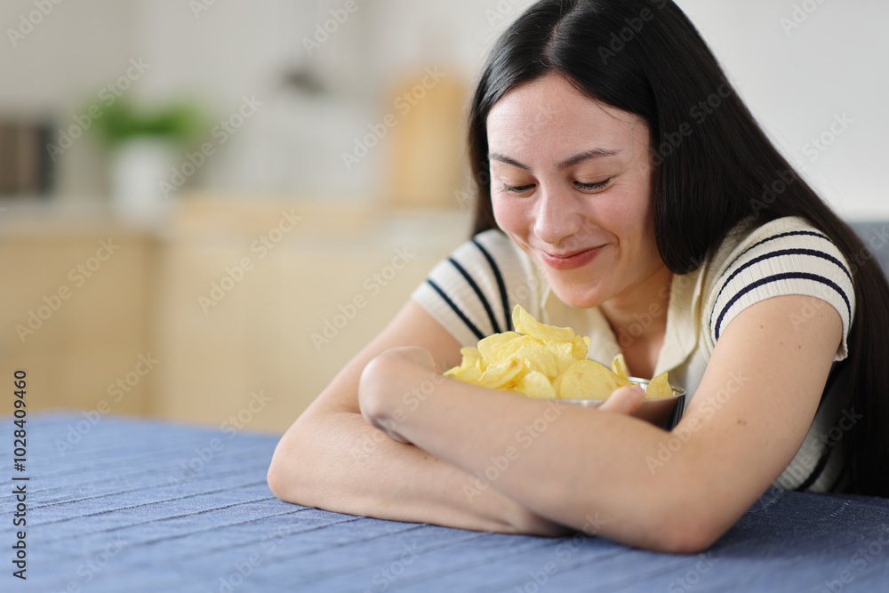 Gluttonous asian woman ready to eat potato chips Gluttonous asian woman ready to eat potato chips