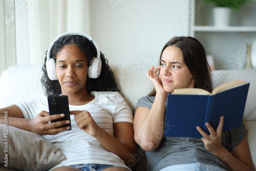 Book reader annoyed by her friend music