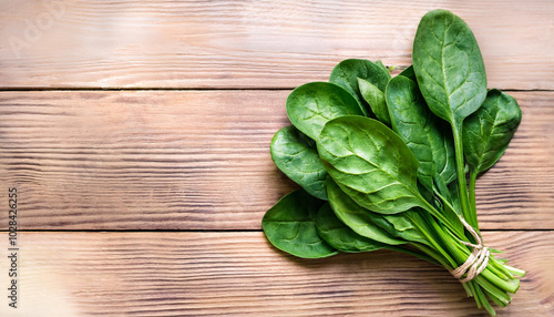 Green Fresh Spinach. On a wooden background. Healthy food. Top view. Copy space.