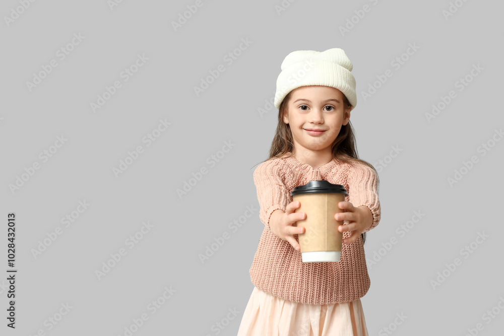 Cute little girl in stylish clothes with cup of coffee on grey background Cute little girl in stylish clothes with cup of coffee on grey background