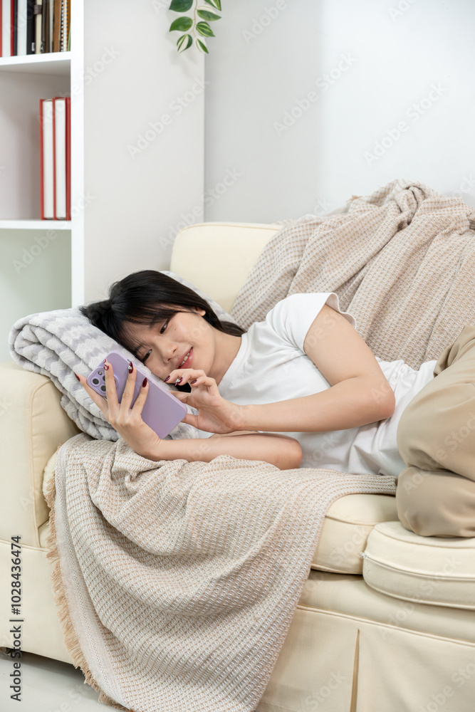 A young Asian woman is relaxing while playing social media. A young Asian woman is relaxing while playing social media.