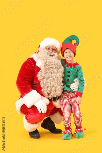 Santa Claus and cute little elf on yellow background