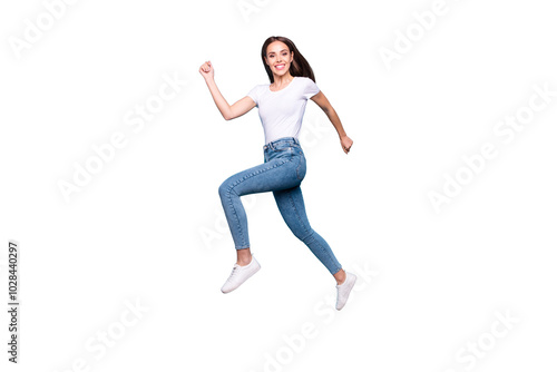 Full length photo of cheerful youth running wearing white t-shirt denim jeans sneakers isolated over blue background