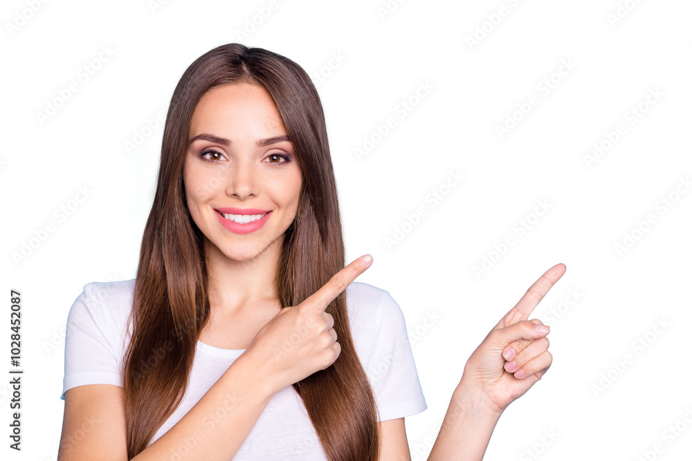 Portrait of lovely millennial pointing at copy space smiling isolatedover blue background Portrait of lovely millennial pointing at copy space smiling isolatedover blue background