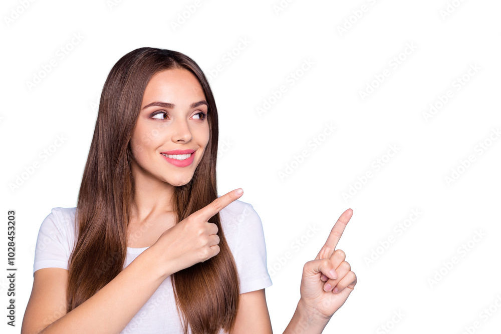 Close up photo of charming lady looking at copy space showing ads wearing white t-shirt isolated over blue background Close up photo of charming lady looking at copy space showing ads wearing white t-shirt isolated over blue background