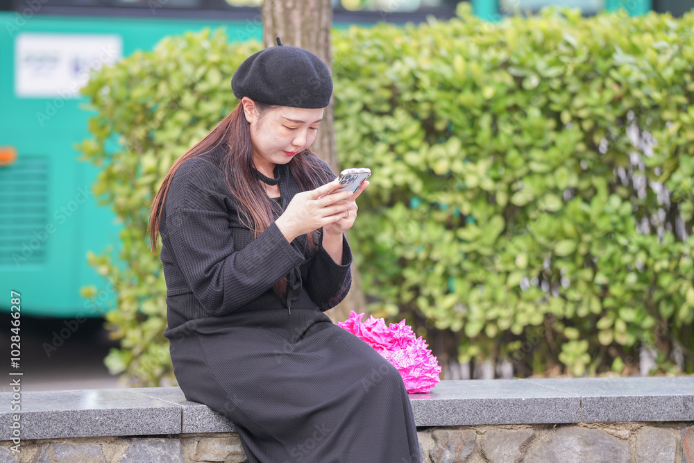 A Japanese woman in her 30s is enjoying a relaxing afternoon at a stylish cafe's terrace in Gyeongchun-ro, Namyangju-si, Gyeonggi-do, Korea. A Japanese woman in her 30s is enjoying a relaxing afternoon at a stylish cafe's terrace in Gyeongchun-ro, Namyangju-si, Gyeonggi-do, Korea.