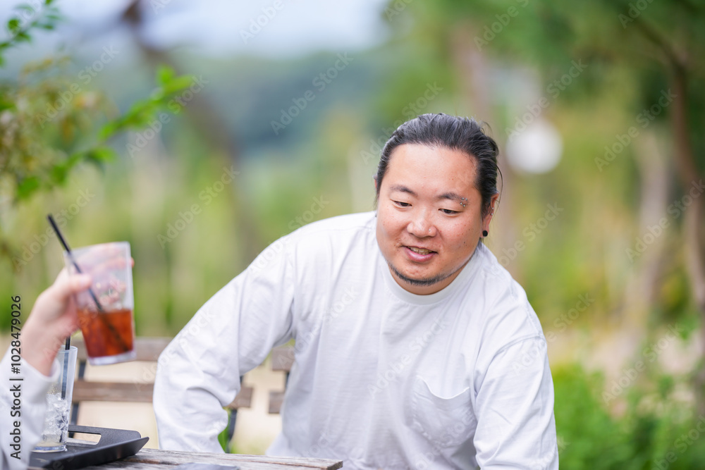 A Korean man in his 30s is enjoying an autumn brunch with three dogs at a stylish cafe located in Gyeongchun-ro, Namyangju-si, Gyeonggi-do, Korea. A Korean man in his 30s is enjoying an autumn brunch with three dogs at a stylish cafe located in Gyeongchun-ro, Namyangju-si, Gyeonggi-do, Korea.
