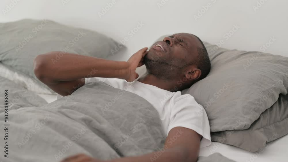 African Man with Toothache Lying in Bed African Man with Toothache Lying in Bed