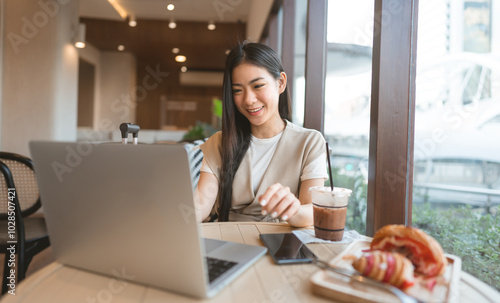 Photography Happy young adult asian woman working at cafe restaurant on table with laptop an