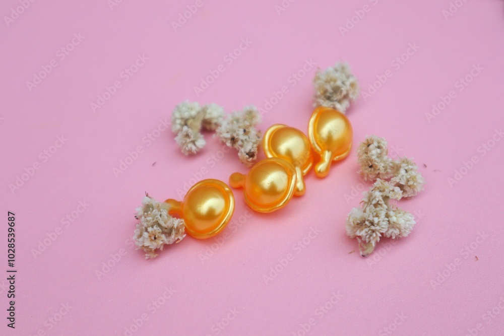 Hair vitamin capsules for hair care, isolated on pink background with close up view. Hair vitamin capsules for hair care, isolated on pink background with close up view.
