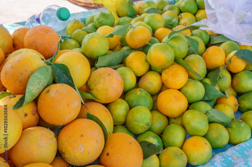 Fresh mandarin oranges or tangerines with leaves on market stall, background, Fresh mandarin oranges or tangerines with leaves on market stall, background,